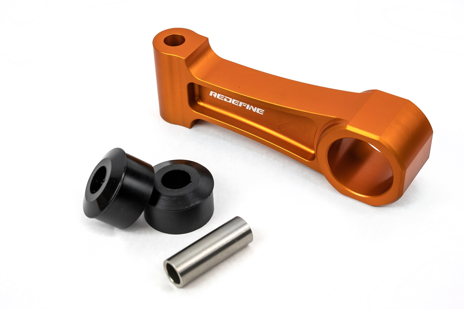 steel-sleeve-poly-and-black-bushings-laid-out-to-compare