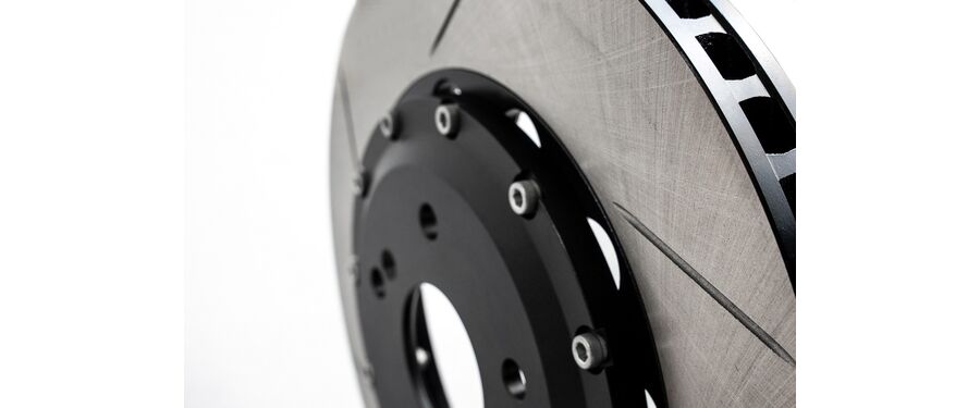 Slotted and vented rotors to aid in cooling under heavy braking